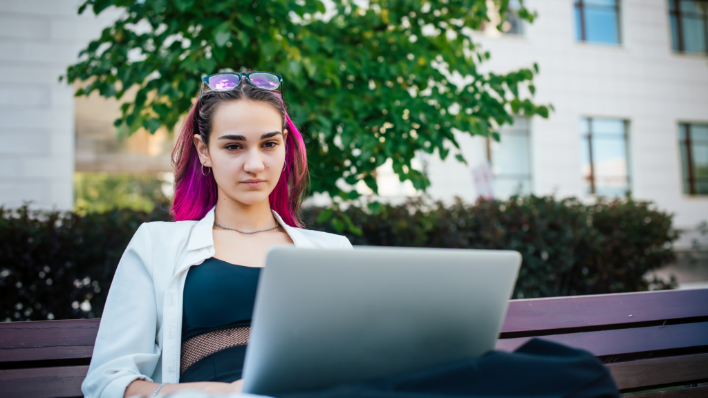 Image of a student with laptop working in the garden
